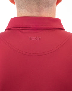 A golf polo that is dark red, like blood, this polo is high performing. It has 4-way stretch, wicks moisture, has an athletic fit and is breathable. 