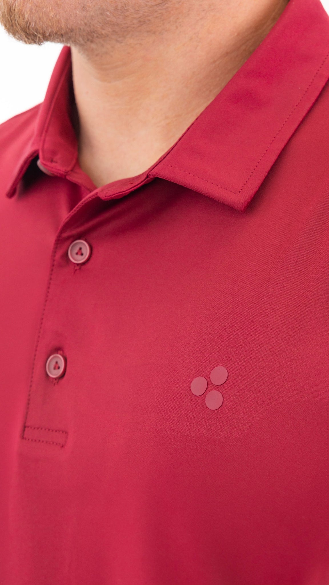 A golf polo that is dark red, like blood, this polo is high performing. It has 4-way stretch, wicks moisture, has an athletic fit and is breathable. 