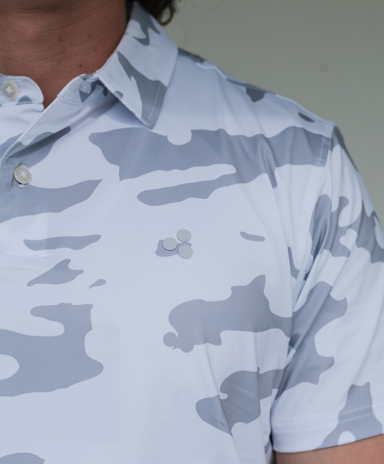 Golf polo with white camp pattern. This polo is breathable, stretchy, moisture wicking, and has an athletic fit. 